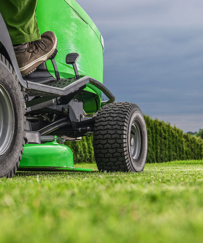 Lawn tractor mowing a yard.